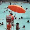 Teen Lifeguard Allegedly Fired for Wearing Modest Swimwear, Sparking Religious Accommodation Debate